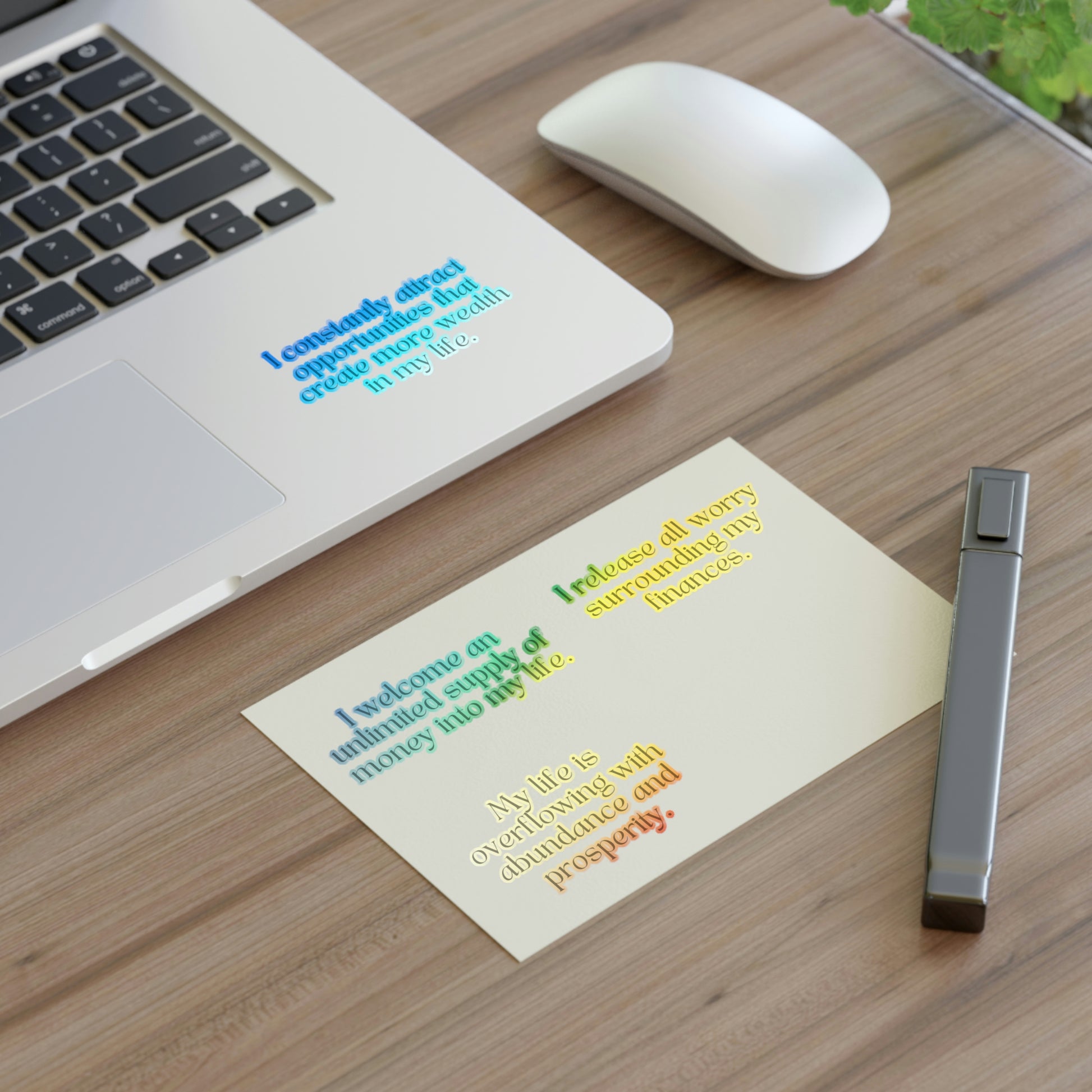 Affirmation word stickers holographic. Displayed on a desk and on laptop to subliminally manifest wealth and easily cultivate an abundance mindset. 